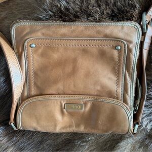 Cole Haan tan leather crossbody with strap.